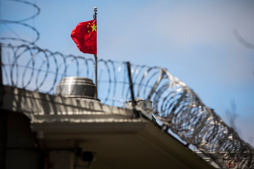 The flag of the People's Republic of China flies behind barbed wire at the Consulate General of the People's Republic of China in San Francisco, California on July 23, 2020.