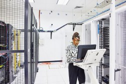 A computer engineer configures a server in a data center.
