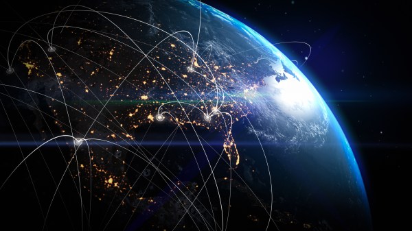 View of Earth from space at night showing illuminated city lights and glowing data network lines connecting various points across continents, symbolizing global communication, technology, and interconnected digital infrastructure.