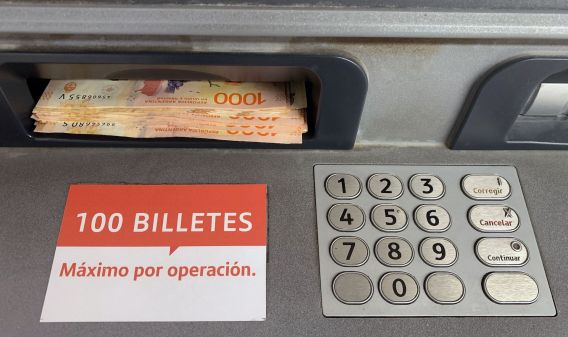 Argentine pesos are withdrawn from an ATM.